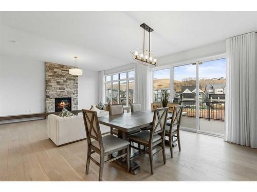 232 Cranbrook Point Se, Calgary, AB - Indoor Photo Showing Dining Room With Fireplace