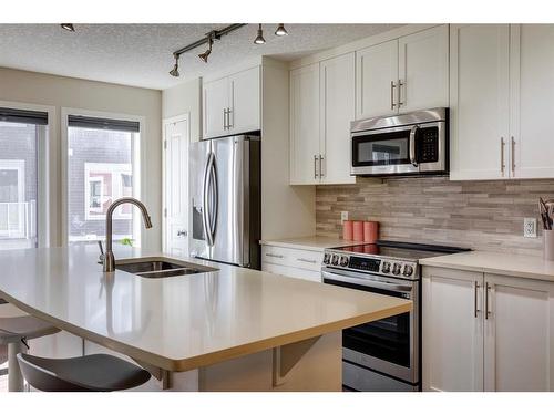 203 Auburn Meadows Walk Se, Calgary, AB - Indoor Photo Showing Kitchen With Stainless Steel Kitchen With Double Sink With Upgraded Kitchen