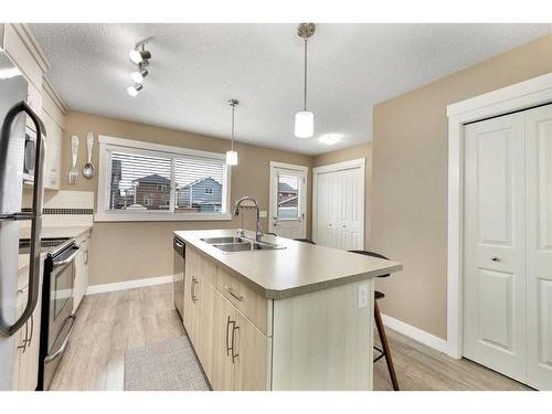 115 Fireside Parkway, Cochrane, AB - Indoor Photo Showing Kitchen With Double Sink