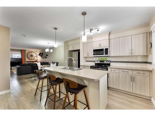 115 Fireside Parkway, Cochrane, AB - Indoor Photo Showing Kitchen With Double Sink With Upgraded Kitchen