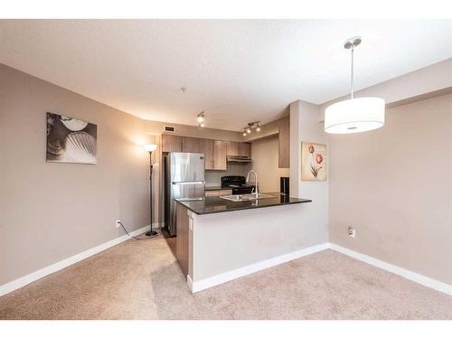 320-7180 80 Avenue Ne, Calgary, AB - Indoor Photo Showing Kitchen With Double Sink