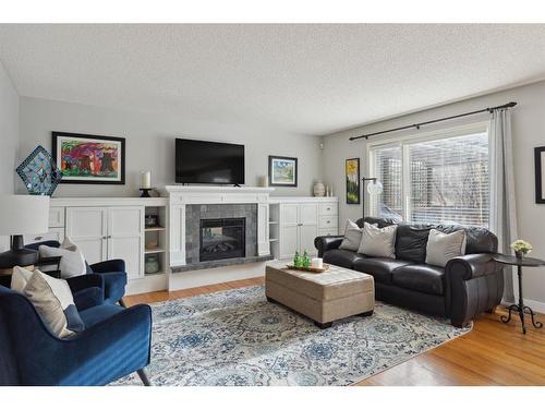 52 Westpoint Gardens Sw, Calgary, AB - Indoor Photo Showing Living Room With Fireplace