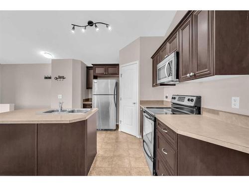 201-30 Panatella Landing Nw, Calgary, AB - Indoor Photo Showing Kitchen With Double Sink