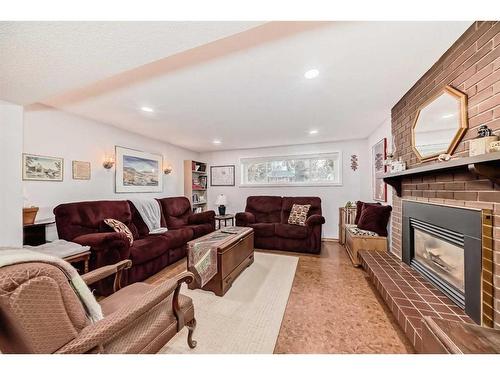 183 Lake Adams Crescent Se, Calgary, AB - Indoor Photo Showing Living Room With Fireplace