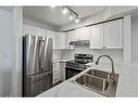 116-92 Saddletree Court Ne, Calgary, AB  - Indoor Photo Showing Kitchen With Double Sink 