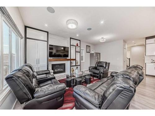 614 Kingsmere Way Se, Airdrie, AB - Indoor Photo Showing Living Room With Fireplace