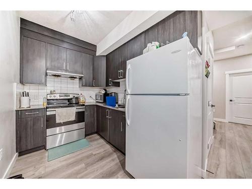 614 Kingsmere Way Se, Airdrie, AB - Indoor Photo Showing Kitchen With Double Sink