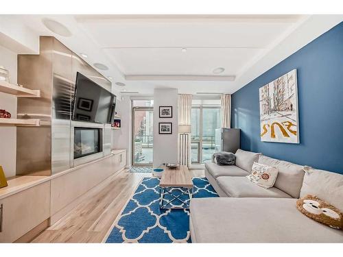 205-701 3 Avenue Sw, Calgary, AB - Indoor Photo Showing Living Room With Fireplace