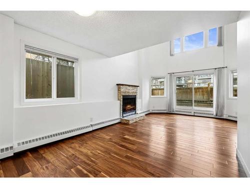 105-1720 13 Street Sw, Calgary, AB - Indoor Photo Showing Living Room With Fireplace