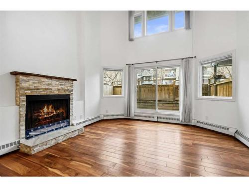 105-1720 13 Street Sw, Calgary, AB - Indoor Photo Showing Living Room With Fireplace