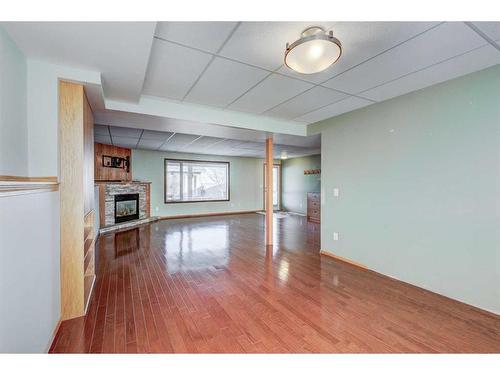 313 Robert Street Sw, Diamond Valley, AB - Indoor Photo Showing Other Room With Fireplace