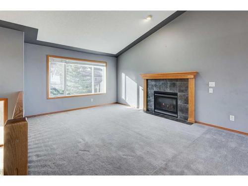 313 Robert Street Sw, Diamond Valley, AB - Indoor Photo Showing Living Room With Fireplace