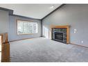 313 Robert Street Sw, Diamond Valley, AB  - Indoor Photo Showing Living Room With Fireplace 