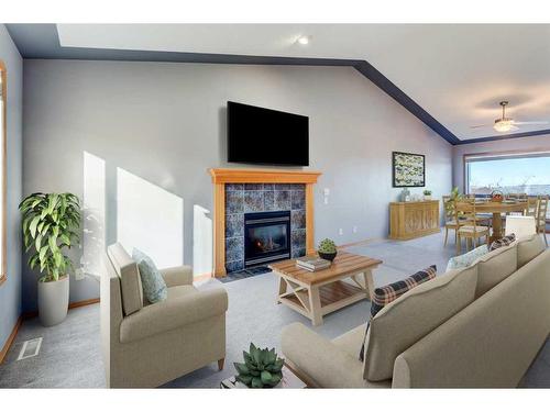 313 Robert Street Sw, Diamond Valley, AB - Indoor Photo Showing Living Room With Fireplace