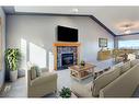 313 Robert Street Sw, Diamond Valley, AB  - Indoor Photo Showing Living Room With Fireplace 