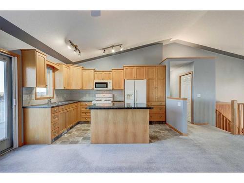 313 Robert Street Sw, Diamond Valley, AB - Indoor Photo Showing Kitchen With Double Sink