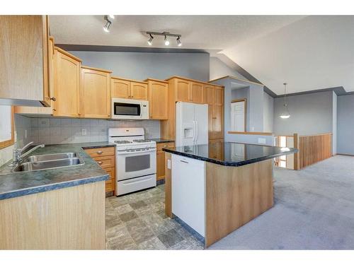 313 Robert Street Sw, Diamond Valley, AB - Indoor Photo Showing Kitchen With Double Sink