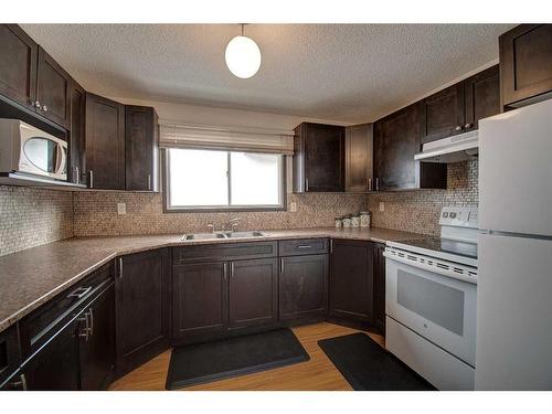 4730 70 Street Nw, Calgary, AB - Indoor Photo Showing Kitchen With Double Sink