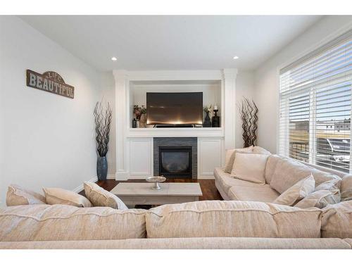 1457 Aldrich Place, Carstairs, AB - Indoor Photo Showing Living Room With Fireplace