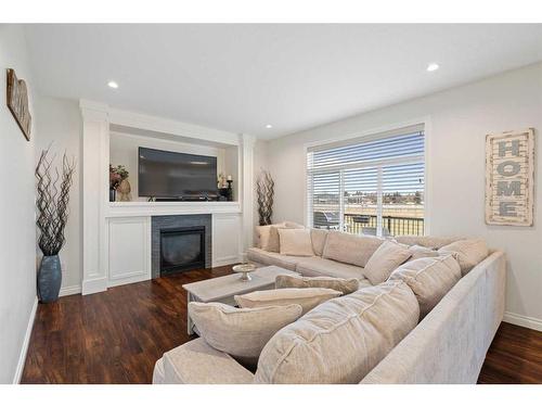 1457 Aldrich Place, Carstairs, AB - Indoor Photo Showing Living Room With Fireplace