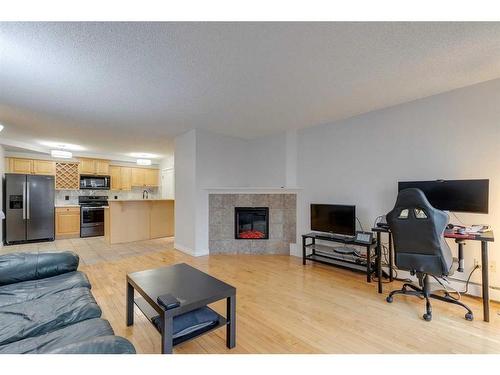 401-1331 15 Avenue Sw, Calgary, AB - Indoor Photo Showing Living Room With Fireplace