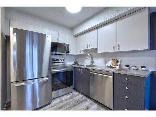 8103-304 Mackenzie Way Sw, Airdrie, AB - Indoor Photo Showing Kitchen With Stainless Steel Kitchen