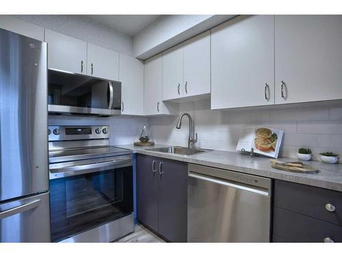 8103-304 Mackenzie Way Sw, Airdrie, AB - Indoor Photo Showing Kitchen With Stainless Steel Kitchen