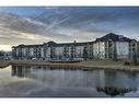 8103-304 Mackenzie Way Sw, Airdrie, AB  - Outdoor With Body Of Water 