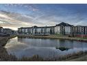 8103-304 Mackenzie Way Sw, Airdrie, AB  - Outdoor With Body Of Water With View 