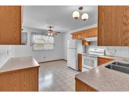 72 Doverglen Crescent Se, Calgary, AB - Indoor Photo Showing Kitchen With Double Sink