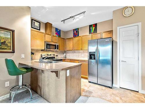 3401-92 Crystal Shores Road, Okotoks, AB - Indoor Photo Showing Kitchen With Stainless Steel Kitchen