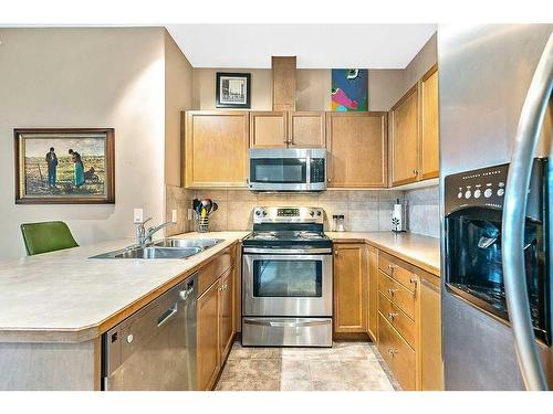 3401-92 Crystal Shores Road, Okotoks, AB - Indoor Photo Showing Kitchen With Stainless Steel Kitchen With Double Sink