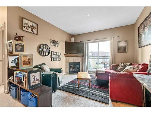 3401-92 Crystal Shores Road, Okotoks, AB - Indoor Photo Showing Living Room With Fireplace