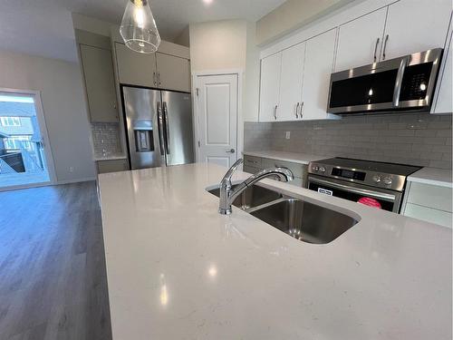 101 Riversong Boulevard, Cochrane, AB - Indoor Photo Showing Kitchen With Double Sink