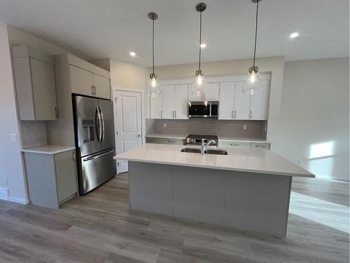 101 Riversong Boulevard, Cochrane, AB - Indoor Photo Showing Kitchen With Upgraded Kitchen