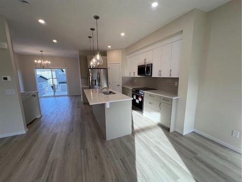 101 Riversong Boulevard, Cochrane, AB - Indoor Photo Showing Kitchen