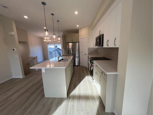 101 Riversong Boulevard, Cochrane, AB - Indoor Photo Showing Kitchen With Upgraded Kitchen