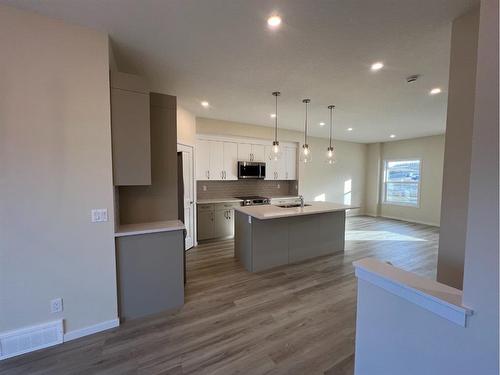 101 Riversong Boulevard, Cochrane, AB - Indoor Photo Showing Kitchen With Upgraded Kitchen