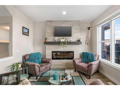 23 Cranbrook Gardens Se, Calgary, AB - Indoor Photo Showing Living Room With Fireplace