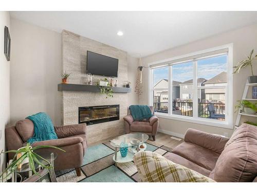 23 Cranbrook Gardens Se, Calgary, AB - Indoor Photo Showing Living Room With Fireplace