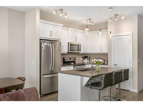 23 Cranbrook Gardens Se, Calgary, AB - Indoor Photo Showing Kitchen With Stainless Steel Kitchen