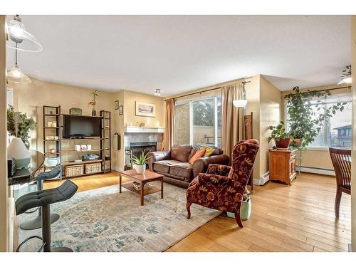 3-203 Village Terrace Sw, Calgary, AB - Indoor Photo Showing Living Room With Fireplace