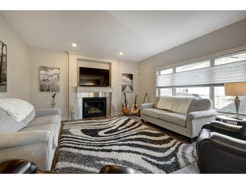 14 Chapalina Green Se, Calgary, AB - Indoor Photo Showing Living Room With Fireplace