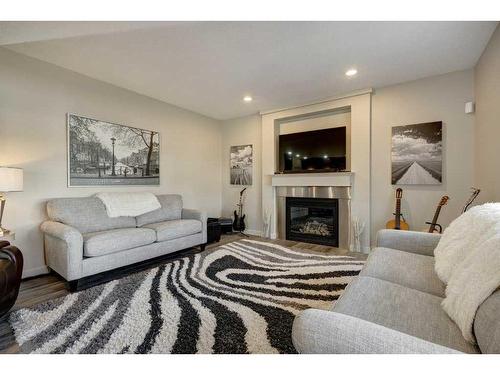 14 Chapalina Green Se, Calgary, AB - Indoor Photo Showing Living Room With Fireplace