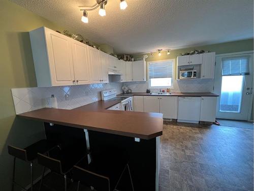 802 Prairie Sound Circle Nw, High River, AB - Indoor Photo Showing Kitchen With Double Sink