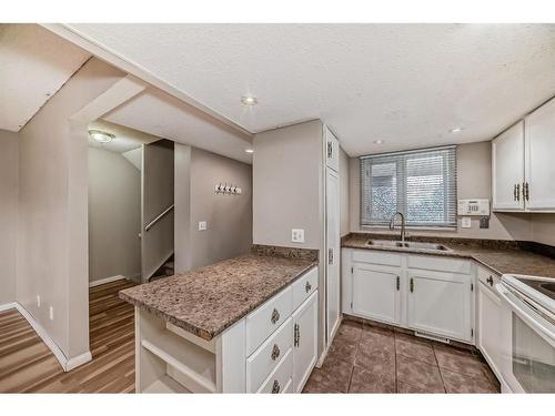 702-360 Falconridge Crescent Ne, Calgary, AB - Indoor Photo Showing Kitchen With Double Sink