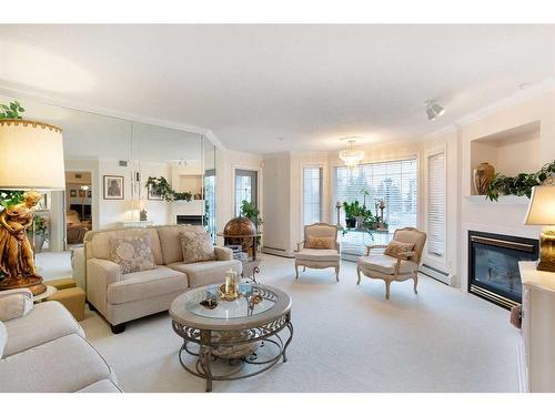 249-8535 Bonaventure Drive Se, Calgary, AB - Indoor Photo Showing Living Room With Fireplace