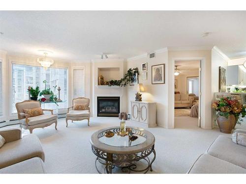 249-8535 Bonaventure Drive Se, Calgary, AB - Indoor Photo Showing Living Room With Fireplace