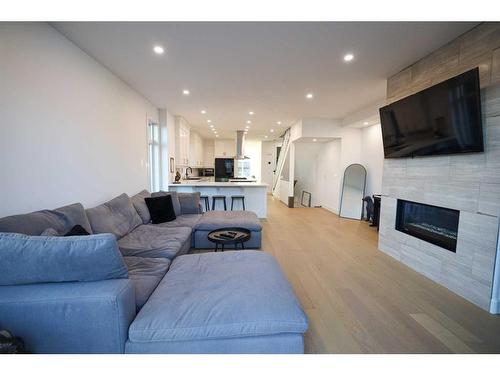 18 27 Avenue Sw, Calgary, AB - Indoor Photo Showing Living Room With Fireplace