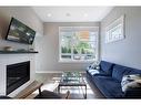 1-138 22 Avenue Ne, Calgary, AB  - Indoor Photo Showing Living Room With Fireplace 